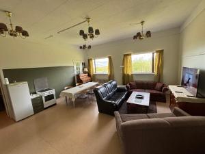 a living room with a couch and a table at Varpholt House Apartments & Rooms in Akureyri