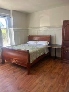 a bed in a bedroom with a wooden floor at six bedroom house in Victoria