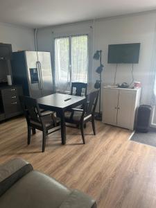 a living room with a dining room table and chairs at Malkom house in Gien