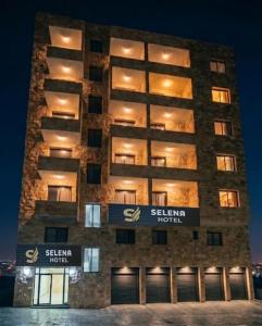 a building with a sign on the side of it at Selena Hotel Aqaba in Aqaba