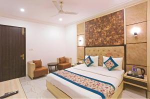 a hotel room with a bed and a chair at Hotel Apple Park - A Boutique Hotel with Free Airport Tranfer in New Delhi