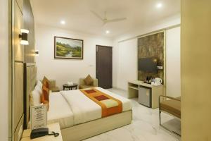 a hotel room with a bed and a desk at Hotel Apple Park - A Boutique Hotel with Free Airport Tranfer in New Delhi +75 photos