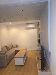 a living room with a couch and a table at Sofija in Radanovići