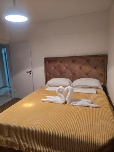 a bedroom with two beds with white towels on them at Sofija in Radanovići