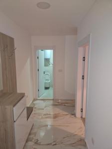 a bathroom with a marble floor and a toilet at Sofija in Radanovići