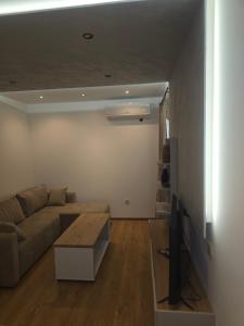 a living room with a couch and a table at Sofija in Radanovići +6 photos