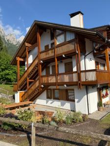 a large house with wooden balconies on it at Appartamento Val Di Roda in San Martino di Castrozza