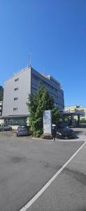 a parking lot with cars parked in front of a building at Sensi Living Dorf in Freienbach