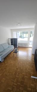 a living room with a couch and a wooden floor at Sensi Living Dorf in Freienbach