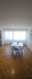 a room with a table and two chairs in it at Sensi Living Dorf in Freienbach