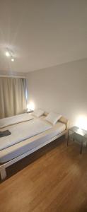 a bedroom with a bed with two pillows and a table at Sensi Living Dorf in Freienbach