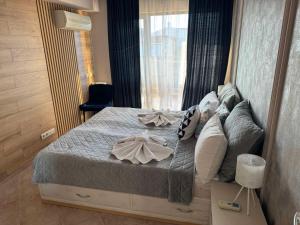 a bedroom with a large bed with pillows at Sun Sea Resort in Ravda +103 photos