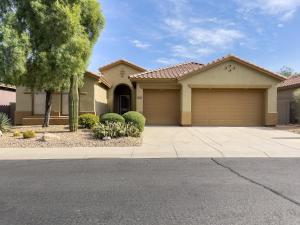 a house with two garage doors on a street at Anthem Allure in Phoenix