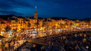 a city at night with boats in a harbor at Sublime Sanary plage in Sanary-sur-Mer