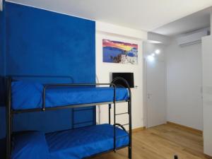 a room with two bunk beds and a blue wall at Pavia Ostello in Pavia +78 photos