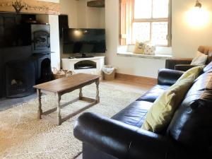 a living room with a couch and a coffee table at Aysgill Cottage in Hawes +6 photos