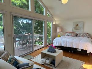 a bedroom with a bed and a living room at Lovely Lakeside Lodge in Canandaigua