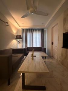 a living room with a couch and a coffee table at 1 BHk, Bed Hall Kitchnett in Lahore