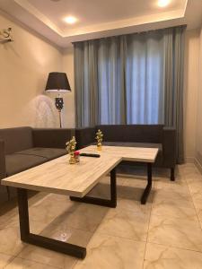 a living room with a table and a couch at 1 BHk, Bed Hall Kitchnett in Lahore