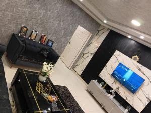 an overhead view of a room with a television and a table at 1 BHk, Bed Hall Kitchnett in Lahore