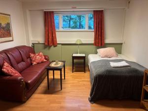 a living room with a couch and a bed at Varpholt House Apartments & Rooms in Akureyri