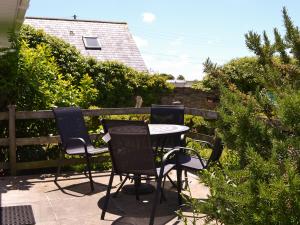 a table and chairs sitting on a patio at Treyarnon in Saint Merryn