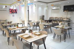 a restaurant dining room with tables and chairs at jPALACE in Bonamoussadi