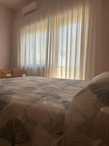 a bedroom with a large bed in front of a window at La Terrazza d'Abruzzo in Guardiagrele