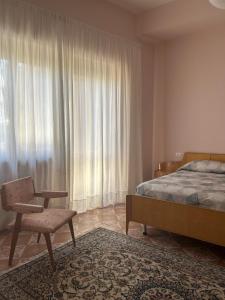 a bedroom with a bed and a chair and a window at La Terrazza d'Abruzzo in Guardiagrele