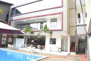 a building with a swimming pool in front of a building at jPALACE in Bonamoussadi