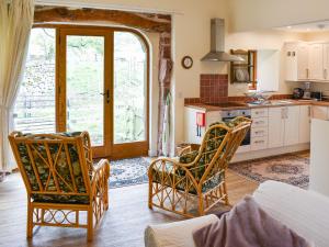 a kitchen with a table and chairs in a room at Cherry Barn in Dufton