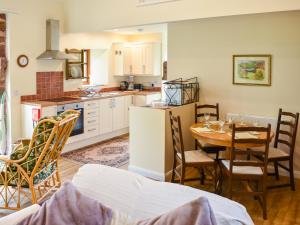 a kitchen and dining room with a table and chairs at Cherry Barn in Dufton