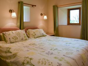 a bedroom with a large bed and a window at Cherry Barn in Dufton +4 photos