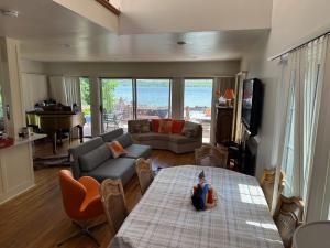 a living room with a couch and a table at Lovely Lakeside Lodge in Canandaigua