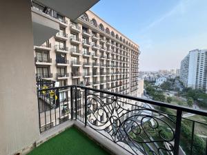 a balcony of a building with a green floor at Velvet stay in Lucknow