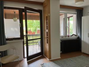a living room with a door open to a balcony at Ferienhaus im Grünen in Weimar