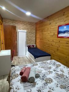 a bedroom with a bed in a wooden wall at Swiss Chalets - Thermas Water Park in Águas de São Pedro
