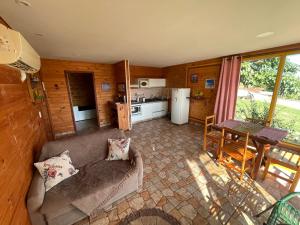a living room with a couch and a kitchen at Swiss Chalets - Thermas Water Park in Águas de São Pedro