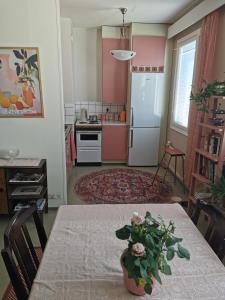 a kitchen with a table with a vase on it at Maribo Street Home in Kaskö