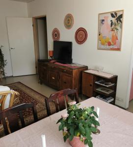 a living room with a table and a television on a cabinet at Maribo Street Home in Kaskö