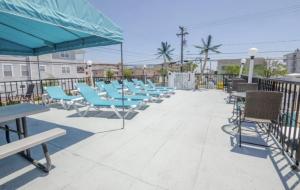 a row of chairs and tables on a patio at Surfcomber Motel in Wildwood