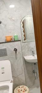a bathroom with a sink and a toilet and a mirror at Hotel rajveer in Jhānsi