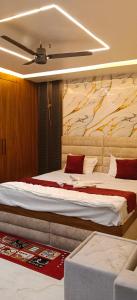 a bedroom with two beds and a ceiling at Hotel rajveer in Jhānsi