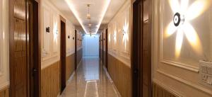 a hallway of a building with wooden doors and a hallwayngth at Hotel rajveer in Jhānsi