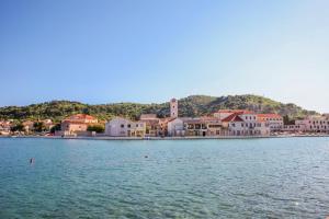 a group of buildings on the shore of a body of water at Apartment Mihovil 308 in Tisno