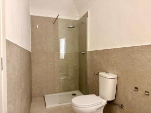 a bathroom with a toilet and a glass shower at Fuga nel borgo in Avigliana