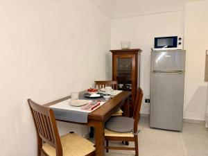 a small kitchen with a table and a refrigerator at Fuga nel borgo in Avigliana +16 photos