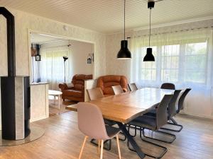 a dining room with a wooden table and chairs at Villa Dångebo in Tingsryd