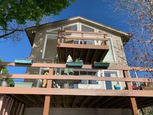 a house with a balcony on top of it at Lovely Lakeside Lodge in Canandaigua
