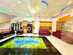 a large living room with a large pool in the floor at Cleopatra villa in Kattankudi
